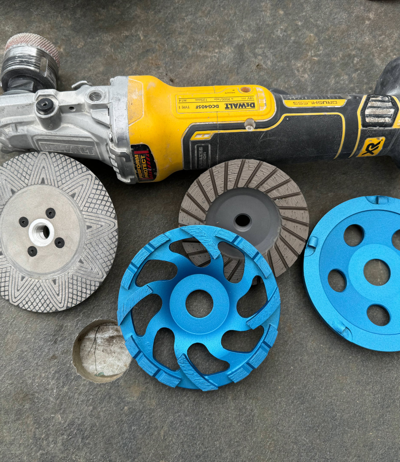 "Assortment of high-performance grinding blades displayed on a tile, showcasing various sizes and designs for different cutting and grinding applications.